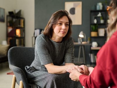 Counseling Session with Female Therapist Holding Hands
